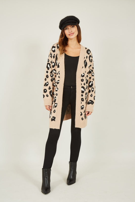Woman wearing a leopard print cardigan on a white background