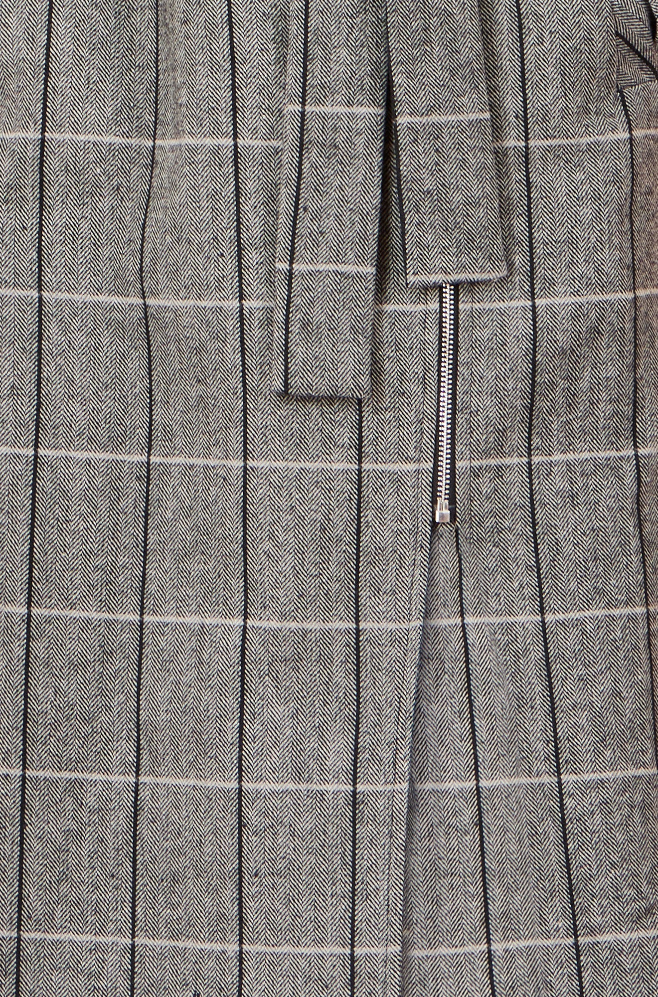 Close-up of a gray suit with pinstripes and a zipper detail.