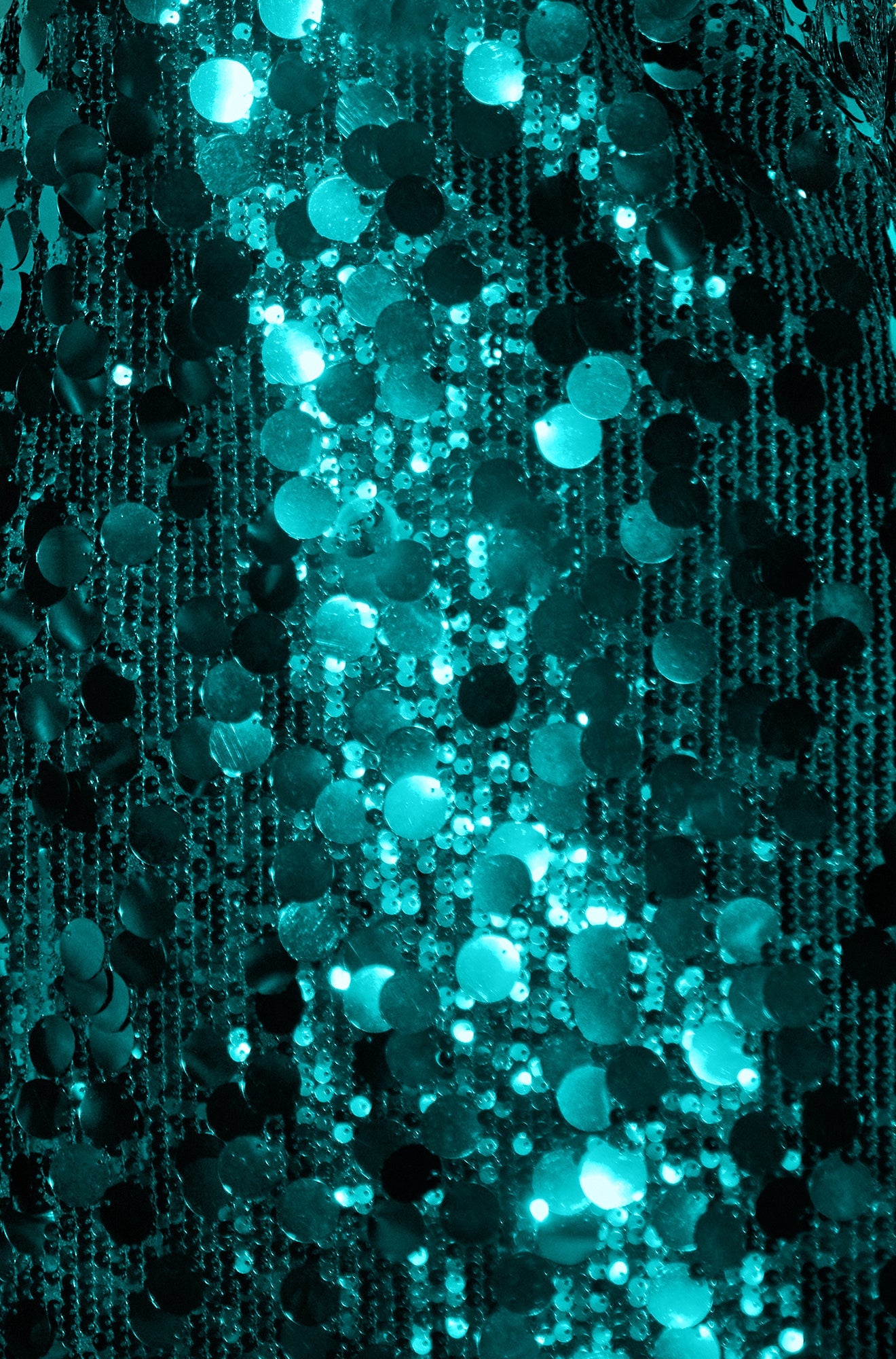 Close-up of a textured fabric with a pattern of small, round, reflective elements.