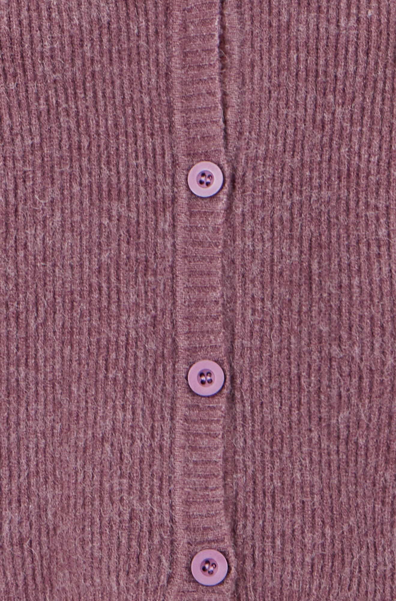 Close-up of a ribbed fabric with buttons on a textured background