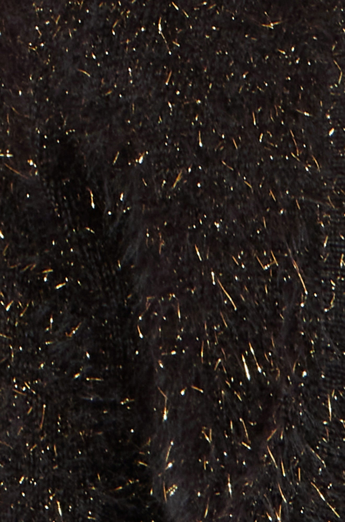 Close-up of a textured black fabric with gold specks